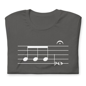 May include: A dark gray t-shirt with a white musical note design. The design features four quarter notes and a bass clef.