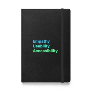 May include: Black leather-bound notebook with the words "Empathy", "Usability", and "Accessibility" printed in blue and green.