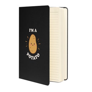 May include: Black notebook with a white design of a smiling potato with the text "I'm a potato".