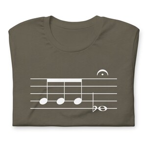 May include: A dark brown t-shirt with a white musical note design. The design features four quarter notes on a staff with a treble clef and a half note.