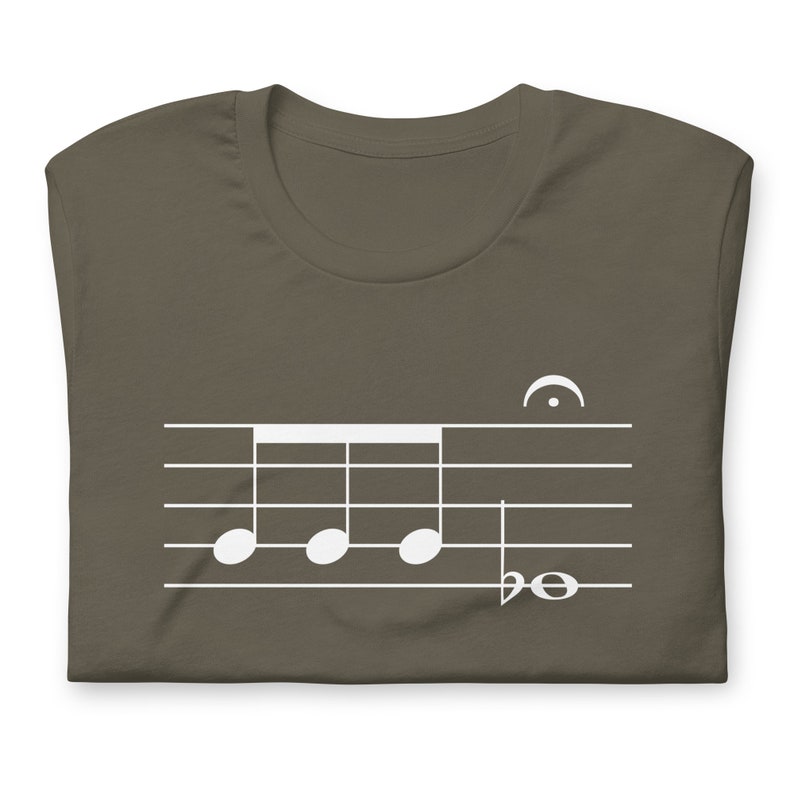 May include: A dark brown t-shirt with a white musical note design. The design features four quarter notes on a staff with a treble clef and a half note.
