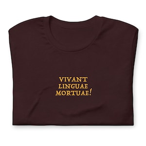 May include: A dark brown t-shirt with the text "VIVANT LINGUAE MORTUAE!" printed in yellow.