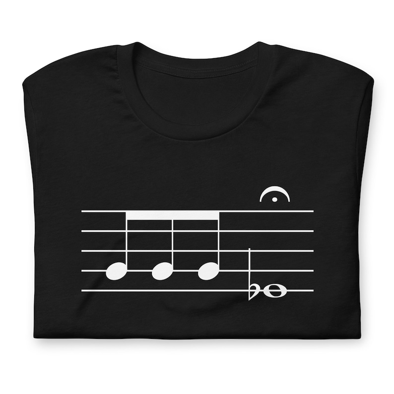 May include: Black t-shirt with a white musical note design. The design features a four-note rhythm with a treble clef and a time signature.