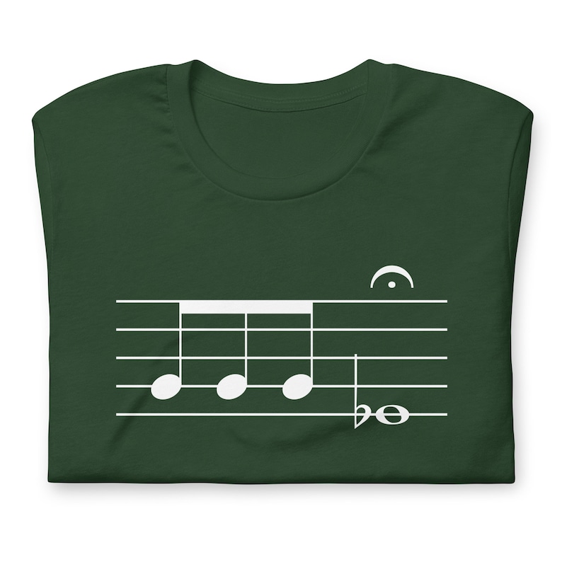 May include: A dark green t-shirt with a white musical note design. The design features four quarter notes and a treble clef.