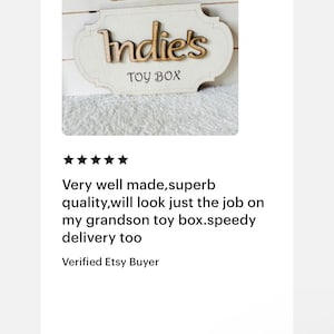 May include: A white wooden toy box with a sign that says "Indie's Toy Box" in brown lettering.