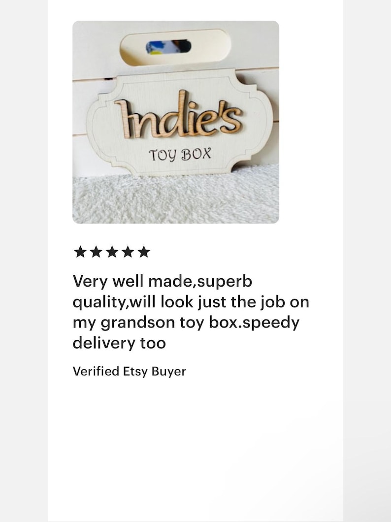 May include: A white wooden toy box with a sign that says "Indie's Toy Box" in brown lettering.