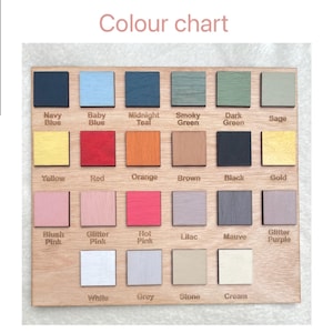 May include: Wooden colour chart featuring painted square samples in various shades. Colours include Navy Blue, Red, Orange, Black, and Gold. The text "Colour chart" is displayed at the top.
