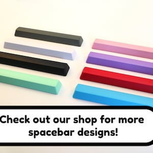 May include: A collection of ten spacebar keycaps in various colors, including gray, white, black, mint green, light purple, pink, red, and blue. The keycaps are arranged in a row, with the text "Check out our shop for more spacebar designs!" below them.
