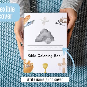 May include: A white, flexible cover Bible coloring book with a watercolor illustration of a dove, a crown of thorns, nails, a stone, a chalice, a cross, a boat with animals, and a loaf of bread. The book has a space to write a name on the cover.  Bible Coloring Book.