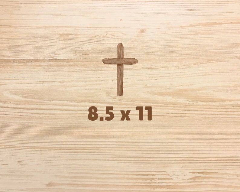 May include: A wooden cross on a light brown wood background with the text "8.5 x 11" below it.