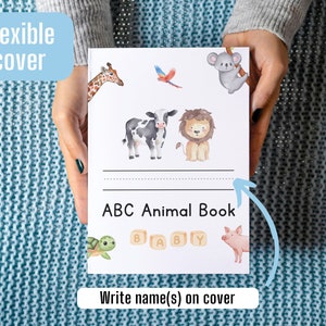 May include: A white book with a flexible cover featuring a colorful illustration of animals. The book title is "ABC Animal Book" and there is space to write a name on the cover.