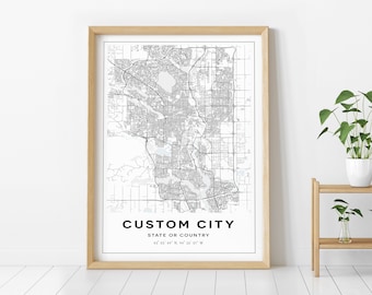 May include: A black and white city map print with the text "CUSTOM CITY, STATE OR COUNTRY, 43° 03' 02" N, 94° 26' 01" W" in a simple font.