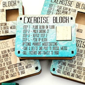 May include: Four wooden blocks with blue and white watercolour backgrounds. Each block has a different set of instructions for an exercise routine. The instructions include "Place block on floor", "Walk around it", "Repeat step 2", "Pick up block", "Optional workout modifications", "Take a selfie and post to social media", and "Call friends and family to brag".
