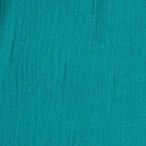 May include: A solid teal fabric with a distinct crinkled, textured surface. The material displays a consistent deep blue-green colour throughout, featuring vertical folds and a lightweight, woven appearance that creates subtle shadows across the textile.