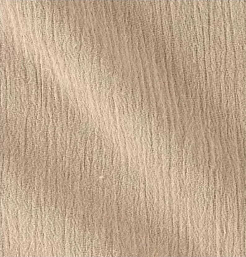 May include: A light beige fabric with a distinct crinkled texture and a visible woven pattern. The material features a soft, matte finish with subtle vertical folds that create a natural, uneven surface appearance across the entire textile.