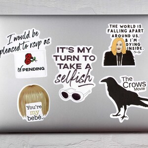 May include: A collection of stickers on a laptop. The stickers feature various designs, including text like "I would be pleased to rsvp as", "It's my turn to take a selfish", and "The world is falling apart around us, & I'm dying inside."