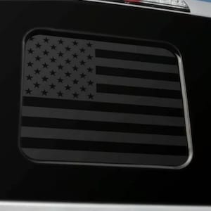 May include: A black and white American flag decal. The flag is in a square shape and has a matte finish.