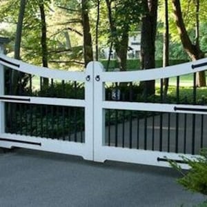 May include: White wooden gate with black metal bars and accents. The gate is closed and has a curved top.
