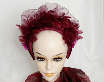 Fascinator hairband in burgundy with veil and orchids