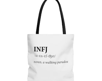 May include: White tote bag with black handles and the text "INFJ /ai-en-ef-dzer/ noun. a walking paradox"