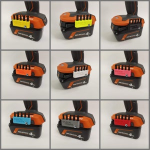 May include: Nine different colored 3D printed battery bit holders for a power drill. The holders are labeled "Galactic Gadgets" and are attached to an orange and black power drill battery.