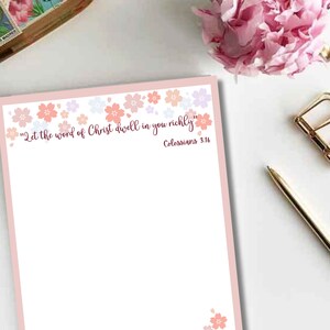 May include: A printable digital download of a pink and white floral design with the quote "Let the word of Christ dwell in you richly" and the scripture reference "Colossians 3:16".