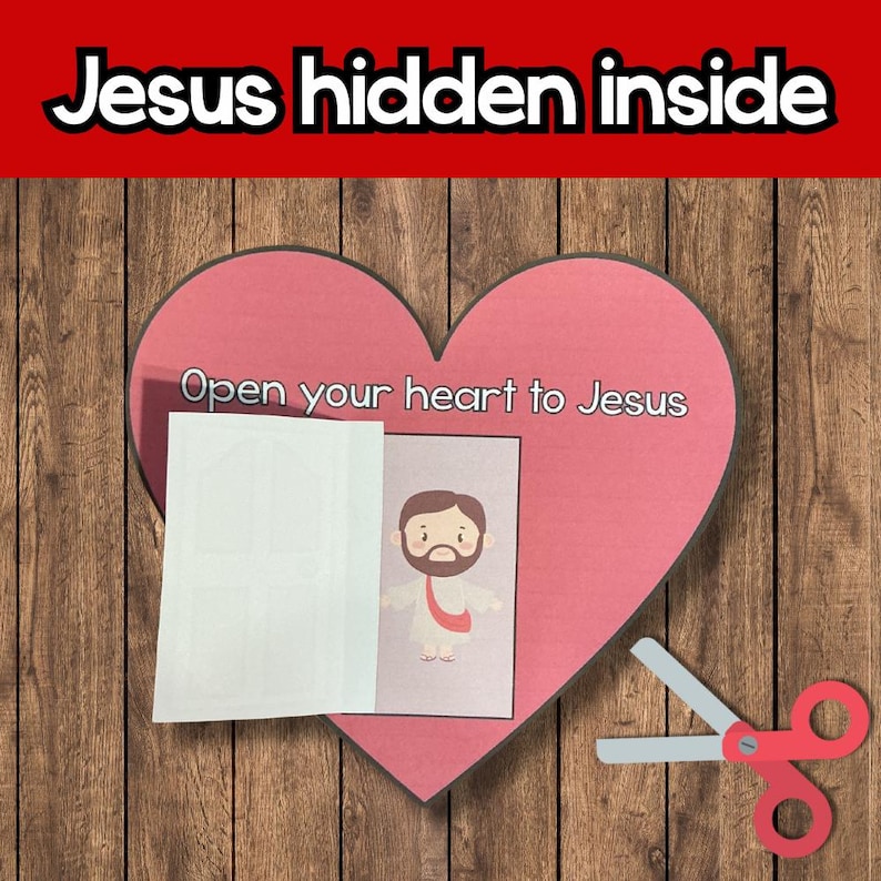 May include: A pink heart-shaped craft with the text "Open your heart to Jesus" and "Jesus hidden inside." A small image of Jesus is visible. A pair of red scissors is on the right side of the image.