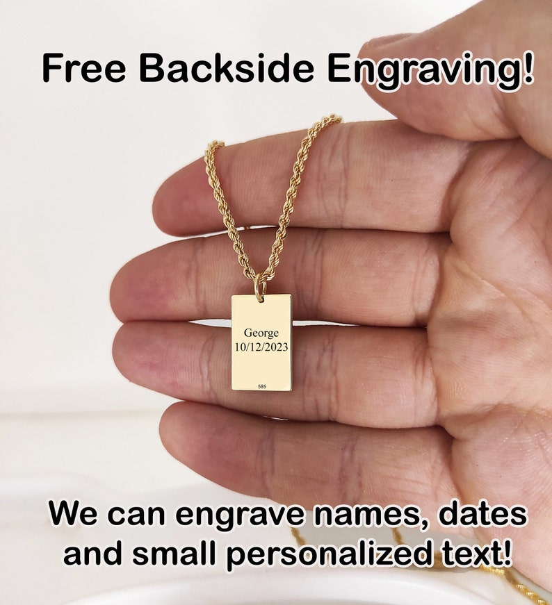 a person is holding a gold necklace with a name tag on it