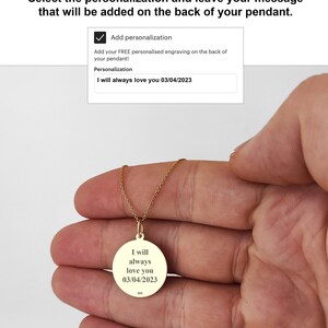 May include: A gold circular pendant necklace featuring the engraved text I will always love you 03/04/2023 and the hallmark 585. The pendant is suspended from a delicate gold chain, showcasing a polished finish and clear, centered black lettering.