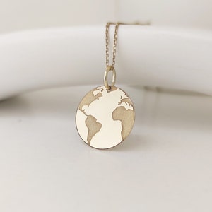 A front image of the same earth map pendant, which has been engraved in a standard style. A unique and modern design that can be gifted for both men and women.