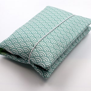 May include: A teal blue fabric pouch with a white wave pattern. The pouch is closed with a white elastic band.