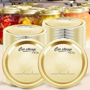 May include: A stack of gold-colored metal lids for canning jars. The lids have a white label with the text "Can storage" and a small graphic of fruit.