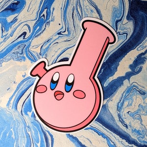 May include: Pink ceramic bong with a cartoon face and blue eyes. The bong has a round body and a long, thin neck.