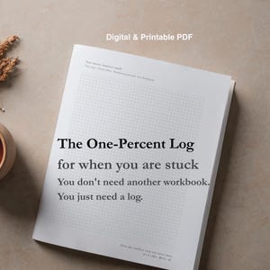 May include: A white digital and printable PDF document titled The One-Percent Log. The page features a grid pattern background with text that reads: The One-Percent Log for when you are stuck. You don't need another workbook. You just need a log.
