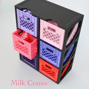 May include: A black storage rack with six rectangular compartments containing small plastic milk crates in purple, light pink, and red. The text New Item appears at the top, and Milk Crates Sold Separately is printed at the bottom.