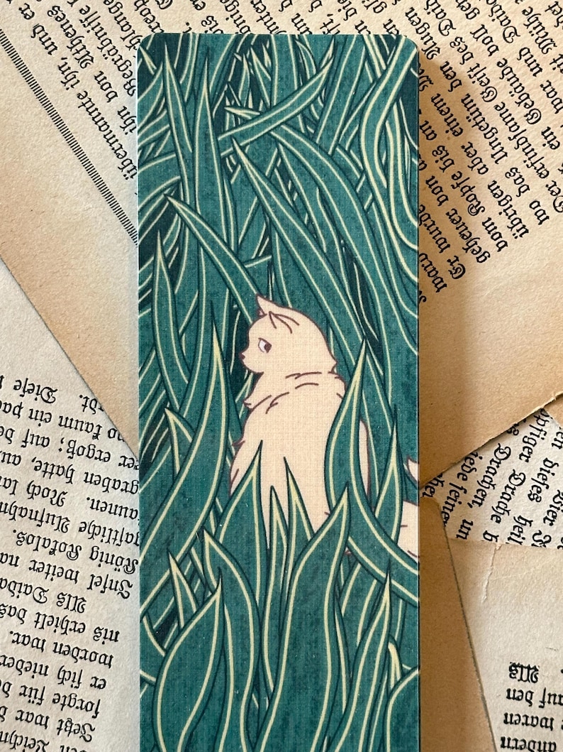 May include: A white cat peeks out from behind a field of tall, green grass. The cat's fur is a soft, creamy white, and its eyes are closed. The grass is a vibrant green, and the background is a soft, blurred green.