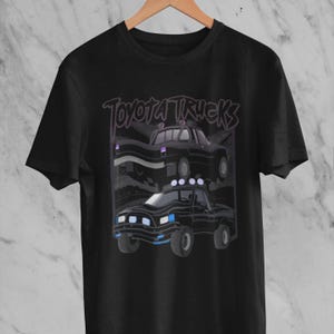 1980s Toyota Hilux Truck Lover T Shirt  Classic Black Pickup Tee with Subtle Race Flag Design