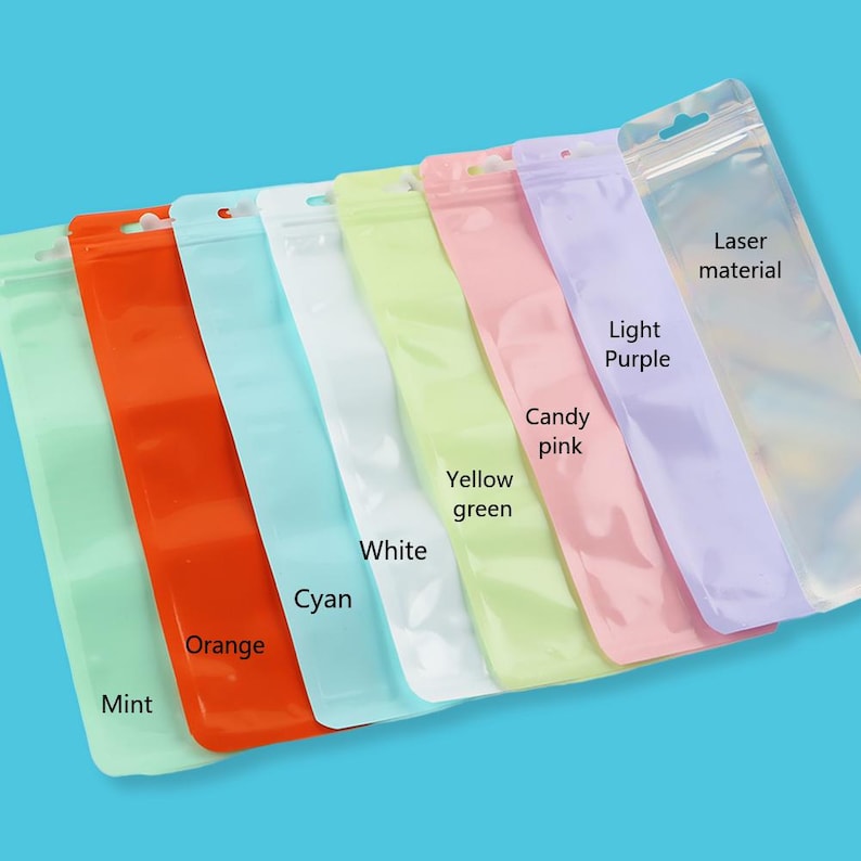 May include: An assortment of colorful, clear plastic zip-top bags. Colors include mint, orange, cyan, white, yellow-green, candy pink, and light purple. The bags are labeled with their respective colors and the words "Laser material."