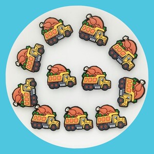 May include: Ten yellow toy dump trucks with a Thanksgiving turkey in the bed of each truck. The trucks are on a white background.