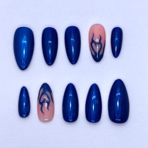 Puede incluir: Un conjunto de diez uñas postizas de varios tamaños. Principalmente de un azul metálico vibrante, con dos uñas con base rosa y un diseño de llama azul. Las uñas tienen un acabado brillante.