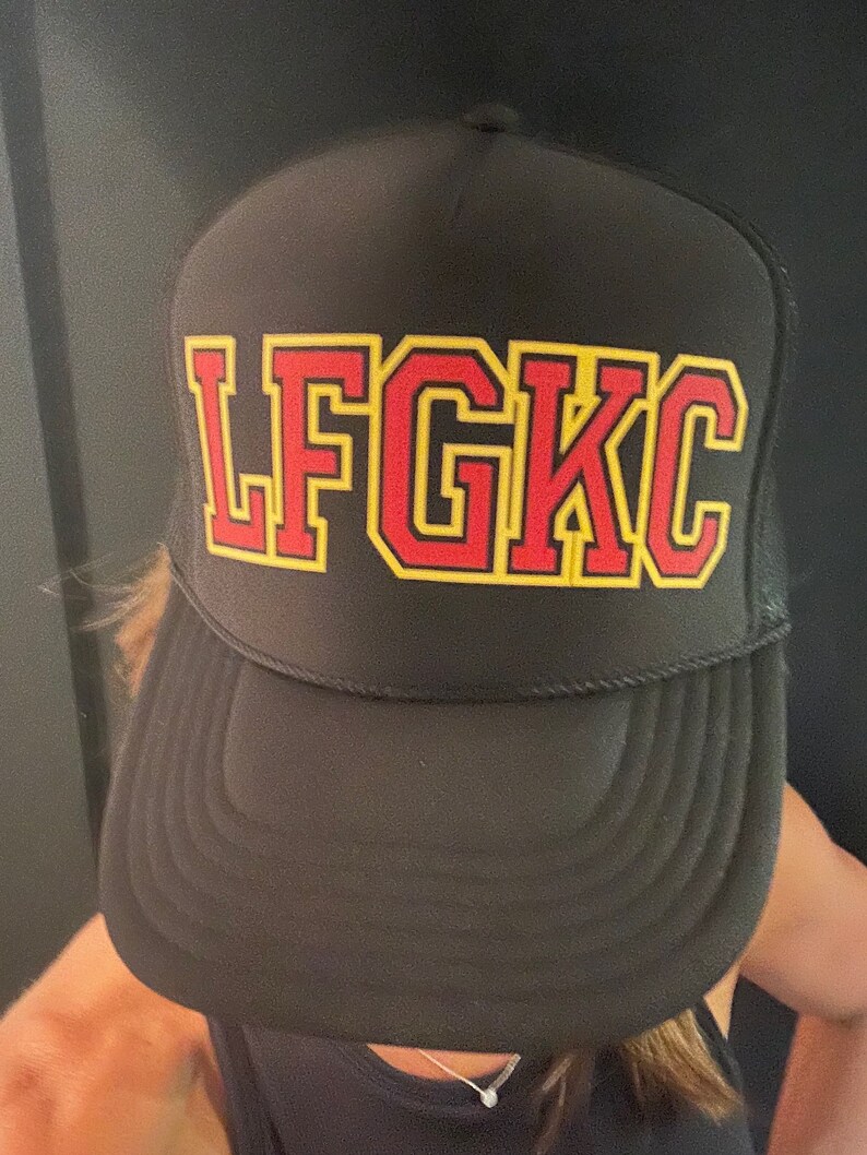 May include: Black mesh trucker hat with a red and yellow embroidered "LFGKC" logo.