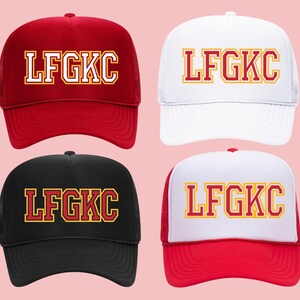 May include: Four trucker hats with the text "LFGKC" in red and yellow letters on a white background. The hats are in black, red, white, and red and white.