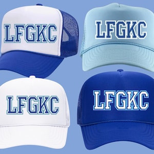 May include: Four trucker hats with a blue and white mesh design. The hats have a blue brim and a white crown with the text "LFGKC" in blue and white letters.