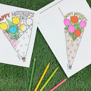 May include: A printable Mother's Day card with a bouquet of flowers. The card is designed to be folded into a cone shape. The flowers are colored in yellow, blue, pink, and red. The text on the card reads "Happy Mother's Day".