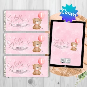 May include: Pink candy bar wrappers and a tablet display featuring a teddy bear holding a pink balloon with the number 1. Text reads "Stella's 1st Birthday! Thank you beary much for coming."
