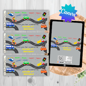 May include: Chocolate bar wrappers with a road design, featuring cars, trucks, and a helicopter. The text reads "Thank you for celebrating JACOBS 4th BIRTHDAY." The wrappers are gray with colorful illustrations.