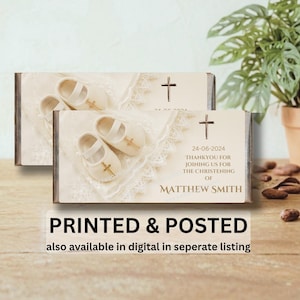 May include: Two rectangular baptism favours with baby shoes, a cross, and the text "24-06-2024 THANKYOU FOR JOINING US FOR THE CHRISTENING OF MATTHEW SMITH". The favours are printed and posted.