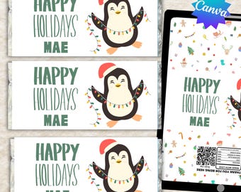 May include: Three rectangular candy bar wrappers featuring a cartoon penguin wearing a red Santa hat and holding a string of colorful Christmas lights. The text reads HAPPY HOLIDAYS MAE in green. A digital tablet displays the same design and a QR code.