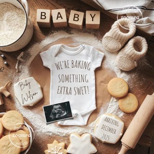 May include: A baby announcement scene with a white onesie that reads "We're Baking Something Extra Sweet!" surrounded by cookies, baby booties, and wooden blocks spelling "BABY". An ultrasound image and a cookie that says "Arriving December 2025" are also present.