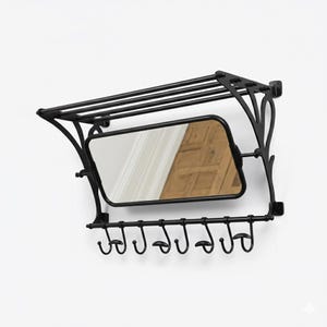 May include: Black metal wall-mounted coat rack with a rectangular mirror and a shelf. The rack has seven hooks below the mirror. The mirror reflects a wooden door. The rack is mounted on a white wall.